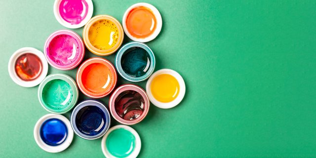 Close-up view of pigment particles in vibrant colors like red, blue, and gold.